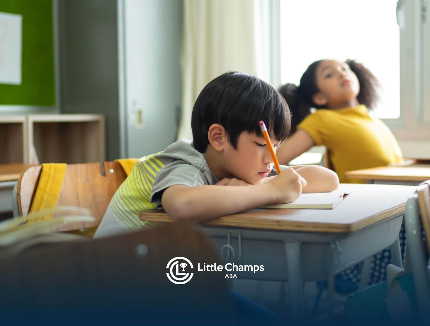 Child with autism focusing on schoolwork while sitting at a classroom desk.