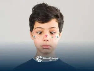 A boy with colorful rhinestones adorning his face, gazes curiously to the side, his expression full of wonder and intrigue.