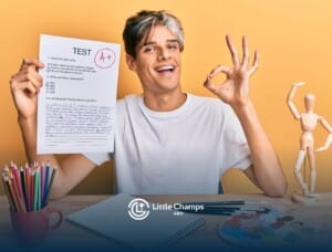 A young ABA therapist holding a test paper with an "A+" grade and making an "OK" gesture with his hand.