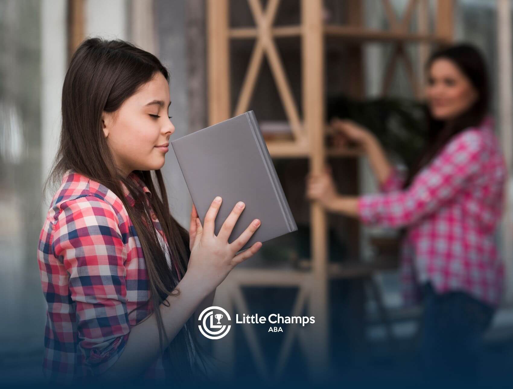 An autistic girl smelling a book while standing near a shelf, with another person visible in the background.