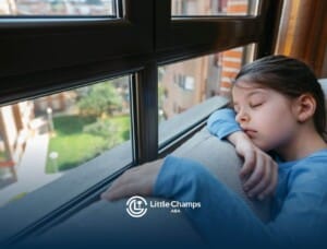 Young girl resting her head on a windowsill during ABA therapy.