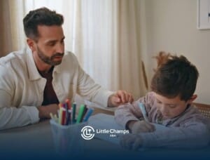 BCBA helping a young boy with homework or schoolwork at a table in ABA therapy.