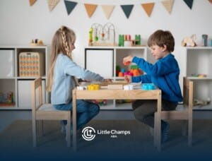 Two young children playing with educational toys at a table during ABA therapy.
