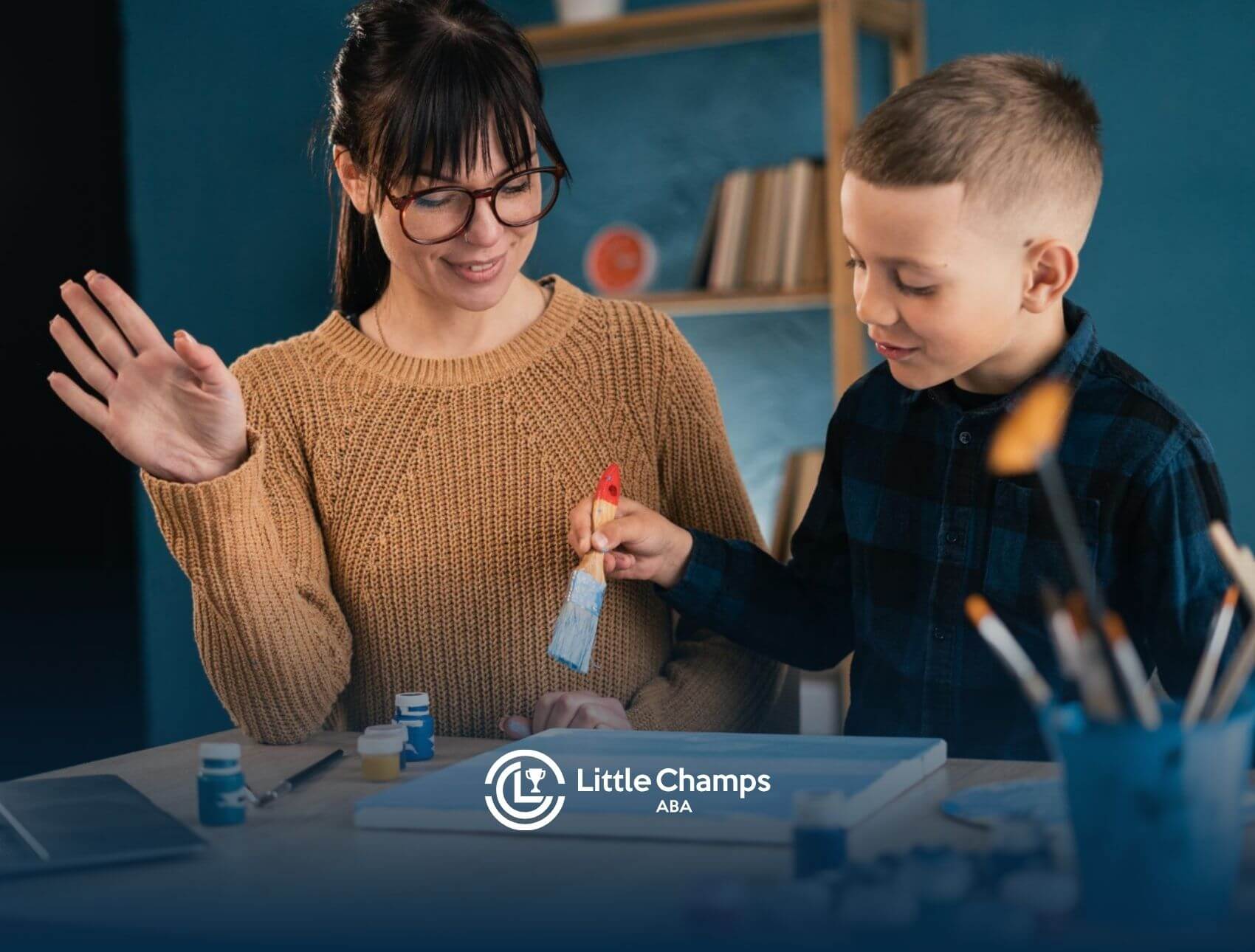 BCBA guiding a child during a painting activity in an ABA therapy session.