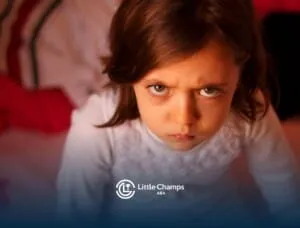 Young child looking upset, showing signs of frustration during a tantrum in ABA therapy.