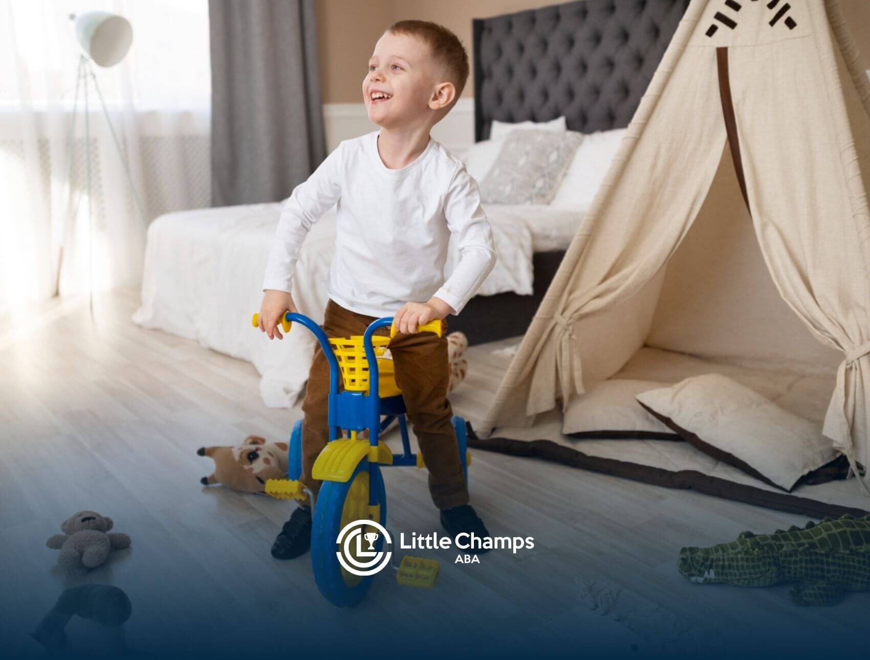 Young boy riding a small tricycle in a bedroom with toys on the floor.