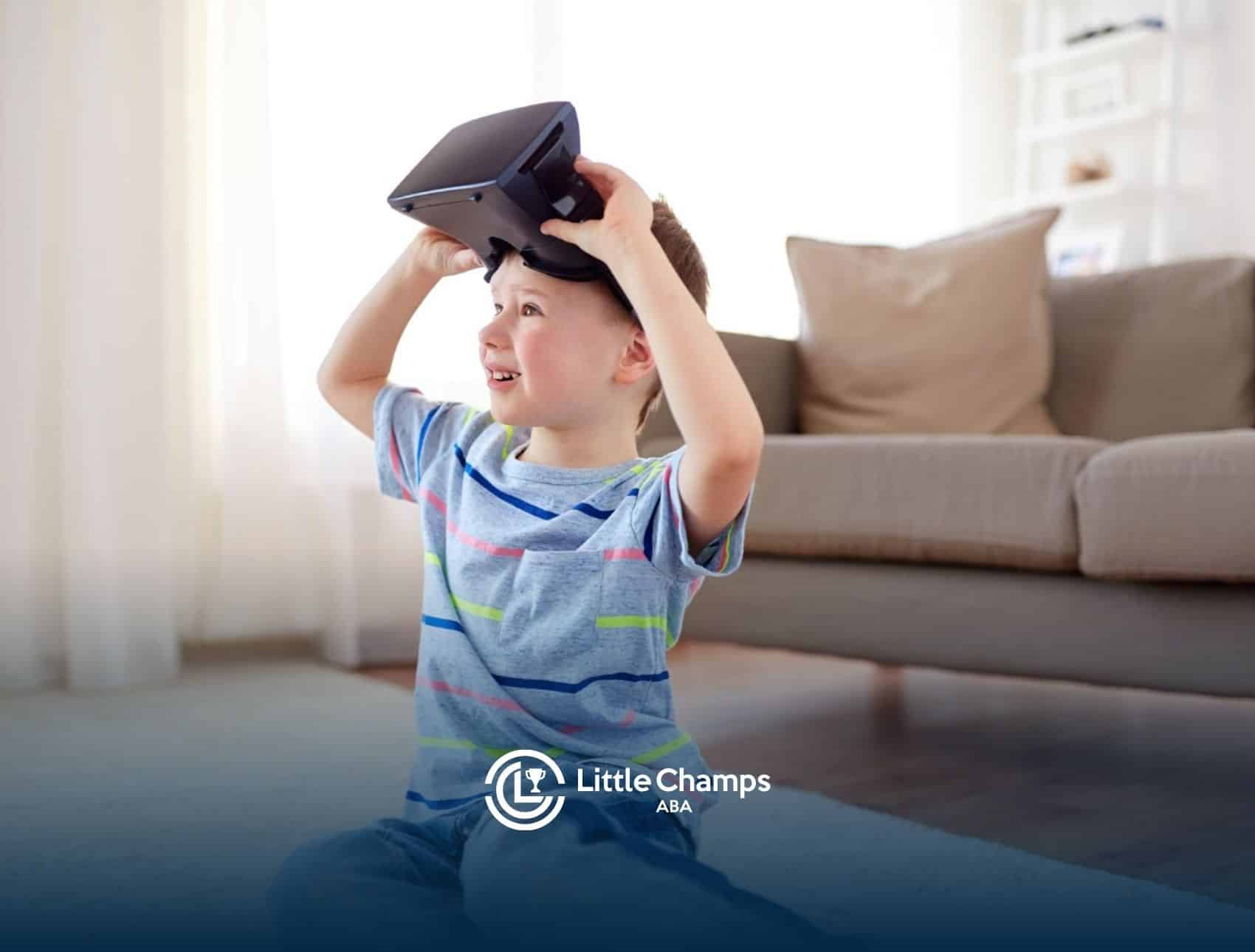 Young child smiling while holding a virtual reality headset above his head in a living room during ABA therapy.