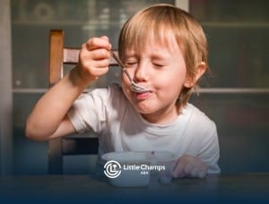 A child with autism eating yogurt.