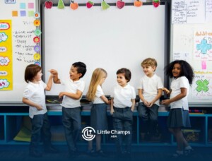 Group of young students with autism standing and interacting in a classroom.