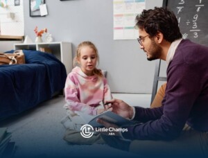 BCBA reading with a young girl sitting on the floor at ABA therapy center.