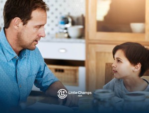 A BCBA having a face-to-face conversation with an autistic boy in ABA therapy.