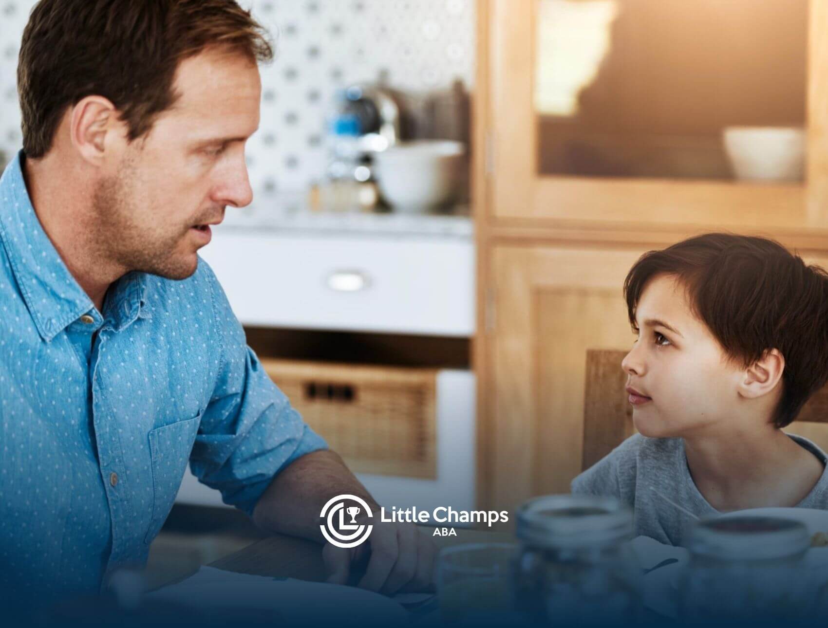 A BCBA having a face-to-face conversation with an autistic boy in ABA therapy.