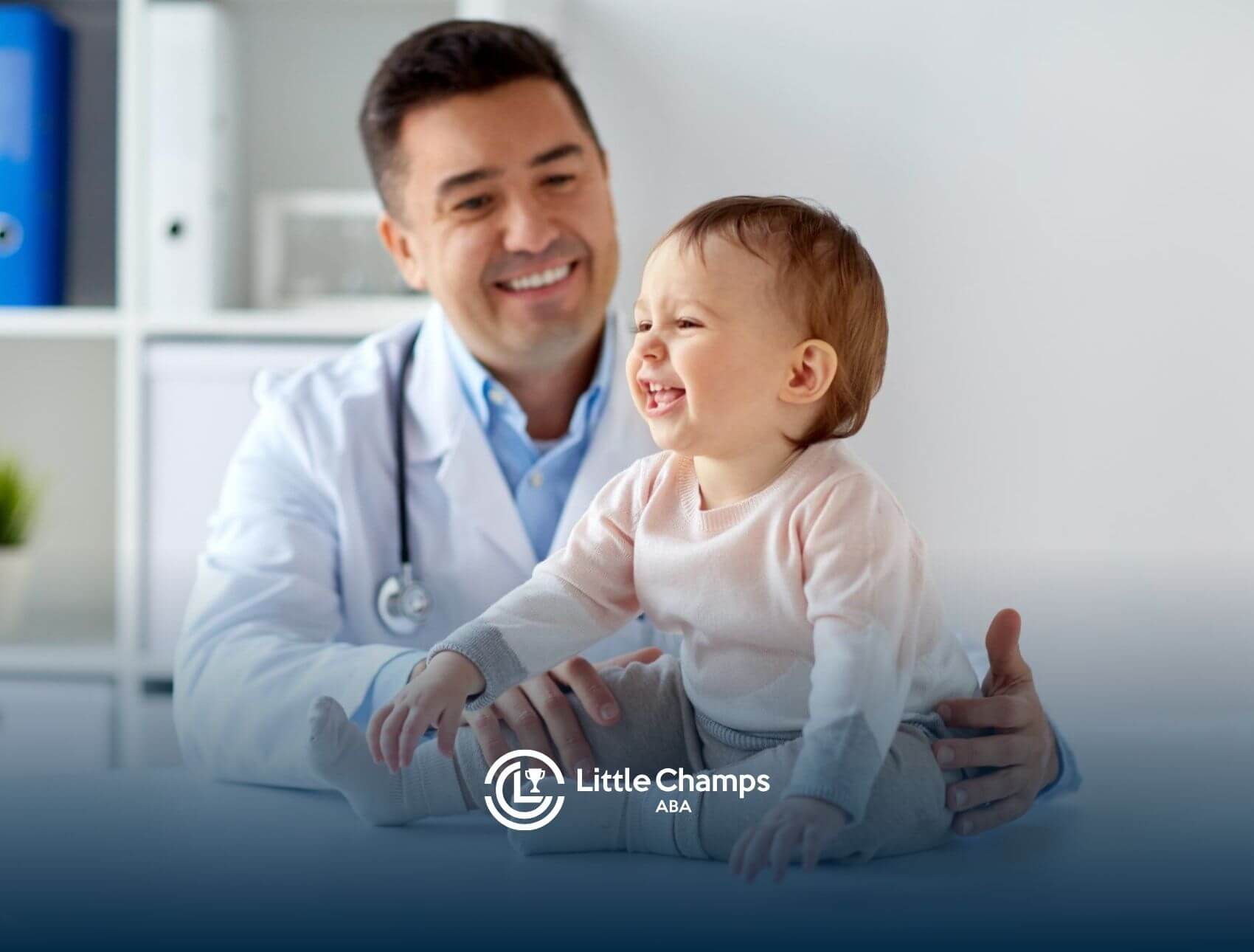 Doctor smiling while examining a happy toddler during an autism diagnosis.