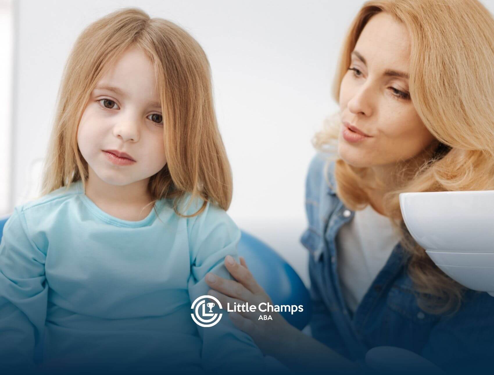 ABA therapist gently talking to young child.