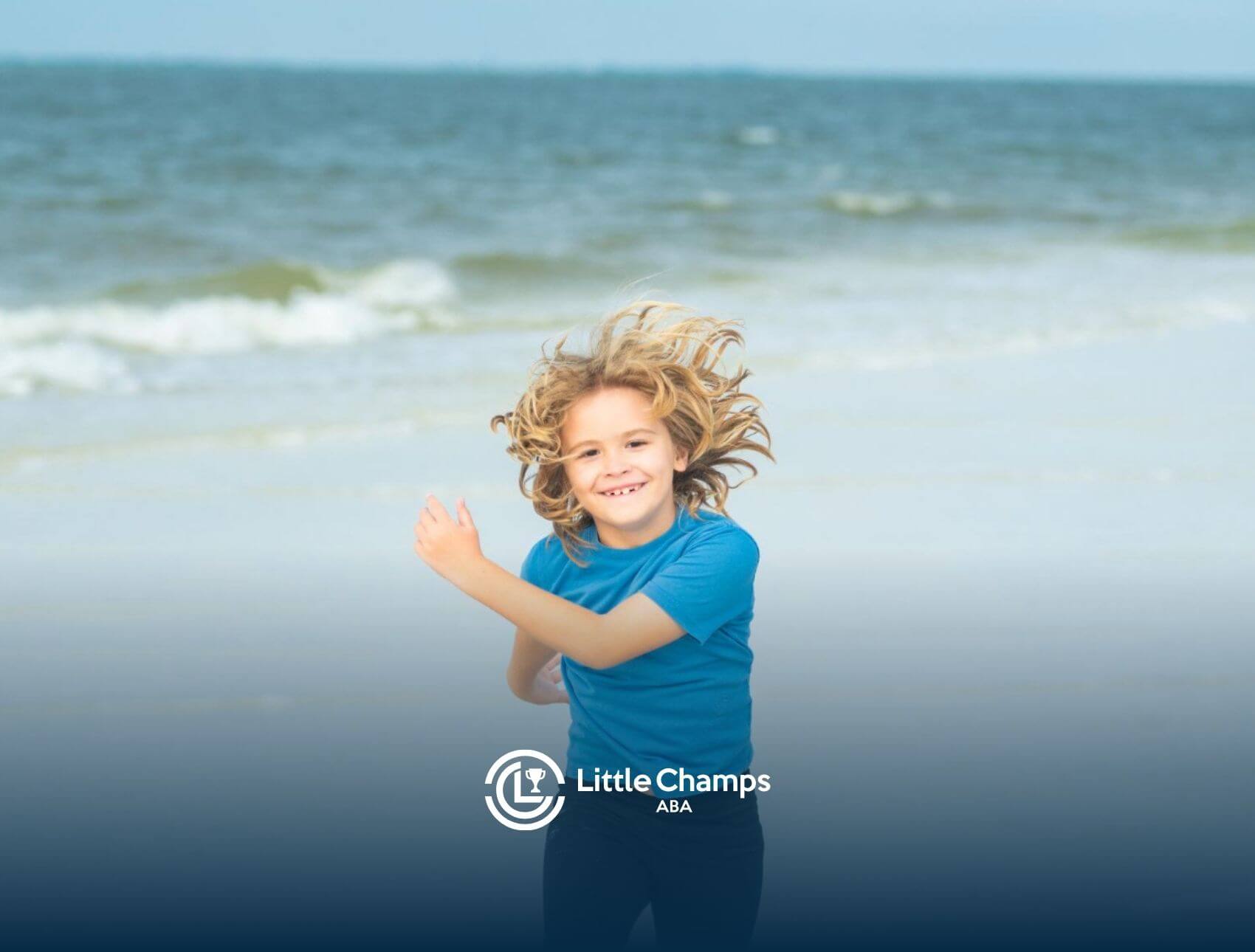 A smiling child with wind-blown hair running on the beach with ocean waves in the background.