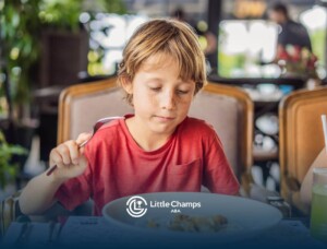 Child with sensory sensitivities eating quietly at a restaurant.