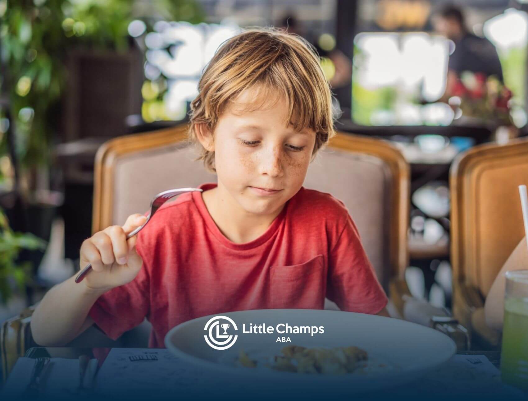 Child with sensory sensitivities eating quietly at a restaurant.