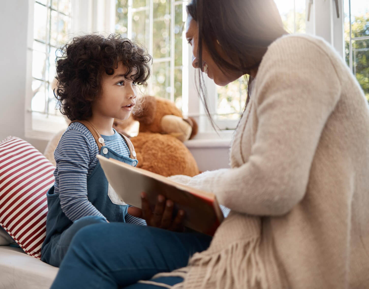 Therapist reading with a child during an in-home ABA therapy session.