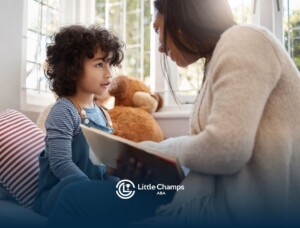 Therapist reading with a child during an in-home ABA therapy session.