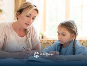 BCBA helping a child with a worksheet at a table during in-home ABA.