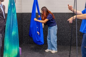 Child using a sensory swing with support at the ABA center.
