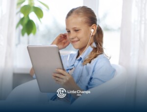 Autistic girl using a tablet and wearing earphones.
