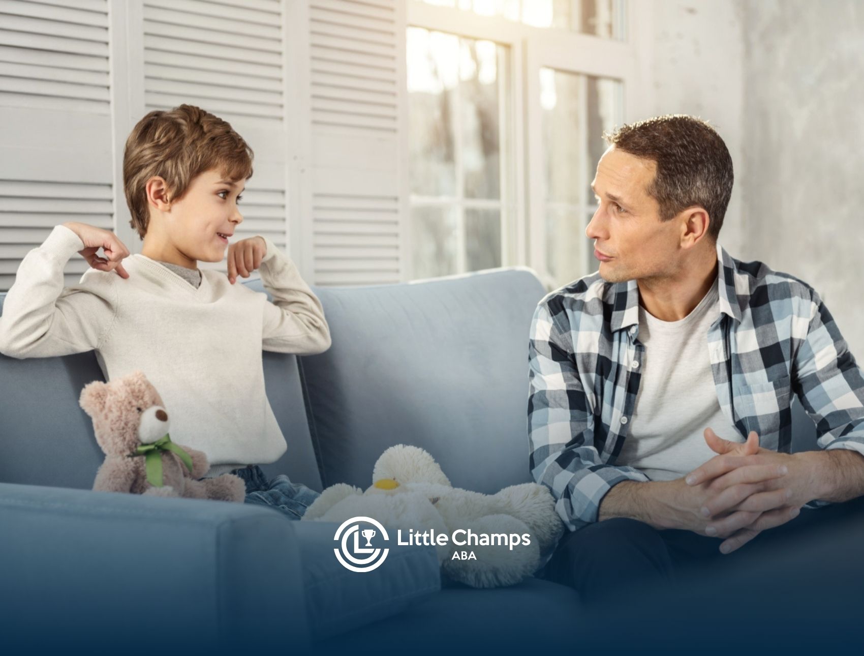 Parent talking with a child on a couch during an ABA therapy session.