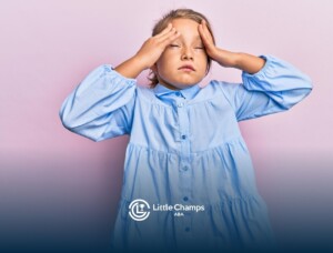 Young girl with autism holding her head with both hands and closing her eyes.