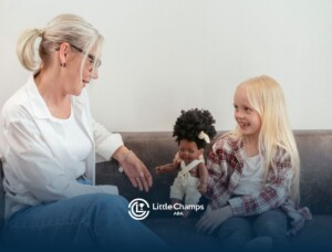 1. ABA therapist engaging a young girl in play-based learning with a doll.