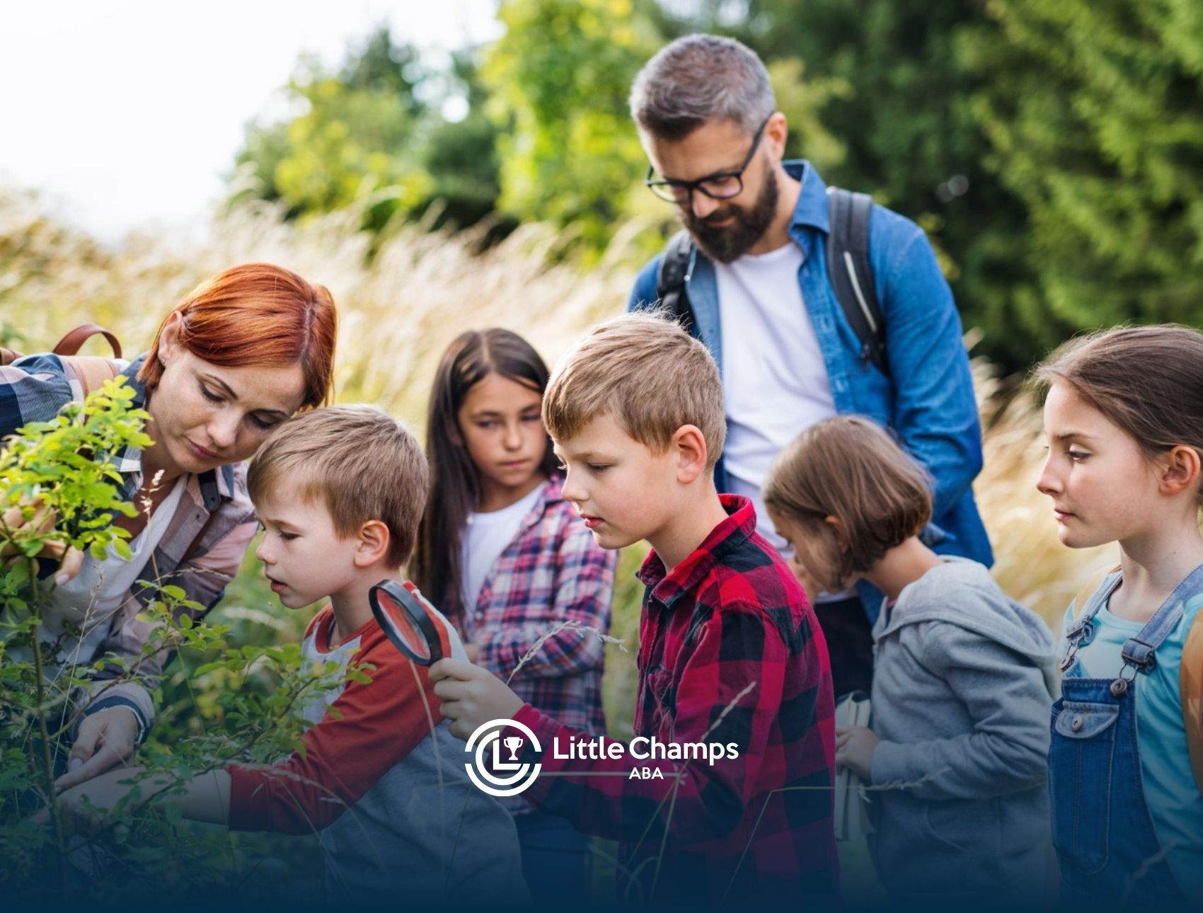 Children, including autistic students, exploring plants with teachers during an outdoor school field trip.