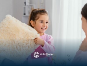 Young girl holding a soft pillow while smiling during a therapy session.